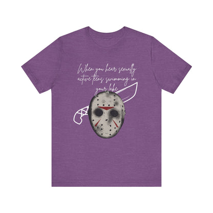 Unisex Comfortable Halloween tee with Jason mask that says 'When you hear sexually active teens swimming in your lake' in color team purple heather