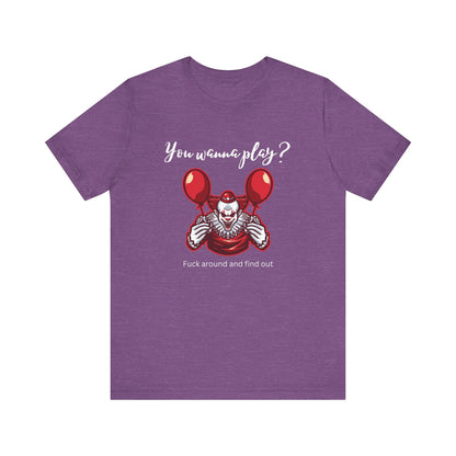 Unisex Halloween Tee stating 'You wanna play? Fuck around and find out.' with Pennywise in color team purple heather.