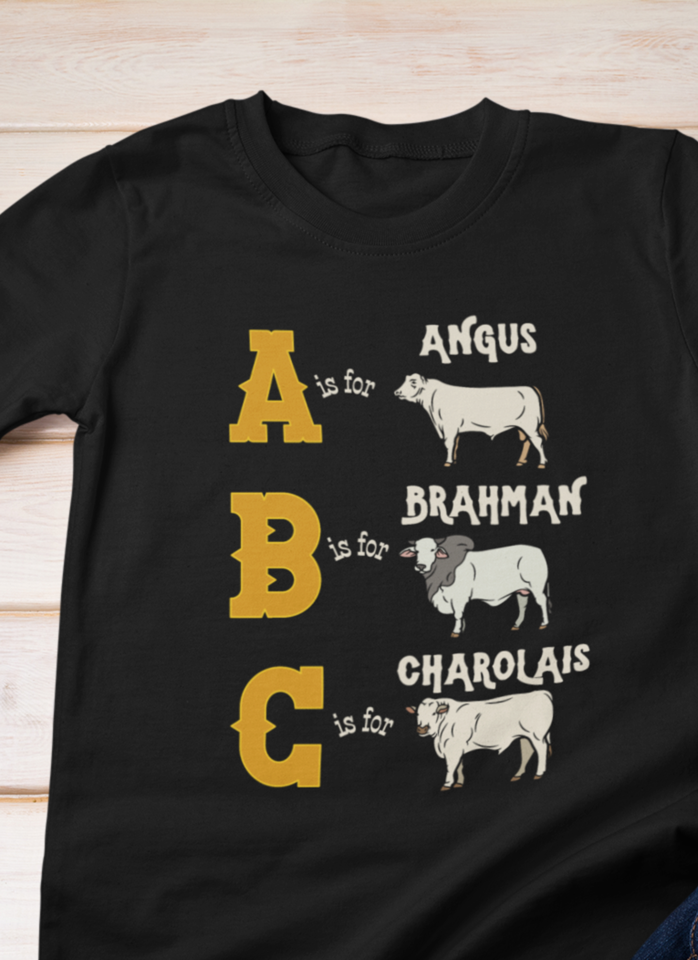 Comfy southern toddler tee stating 'A is for Angus. B is for Brahman. C is for Charolais.' in color black