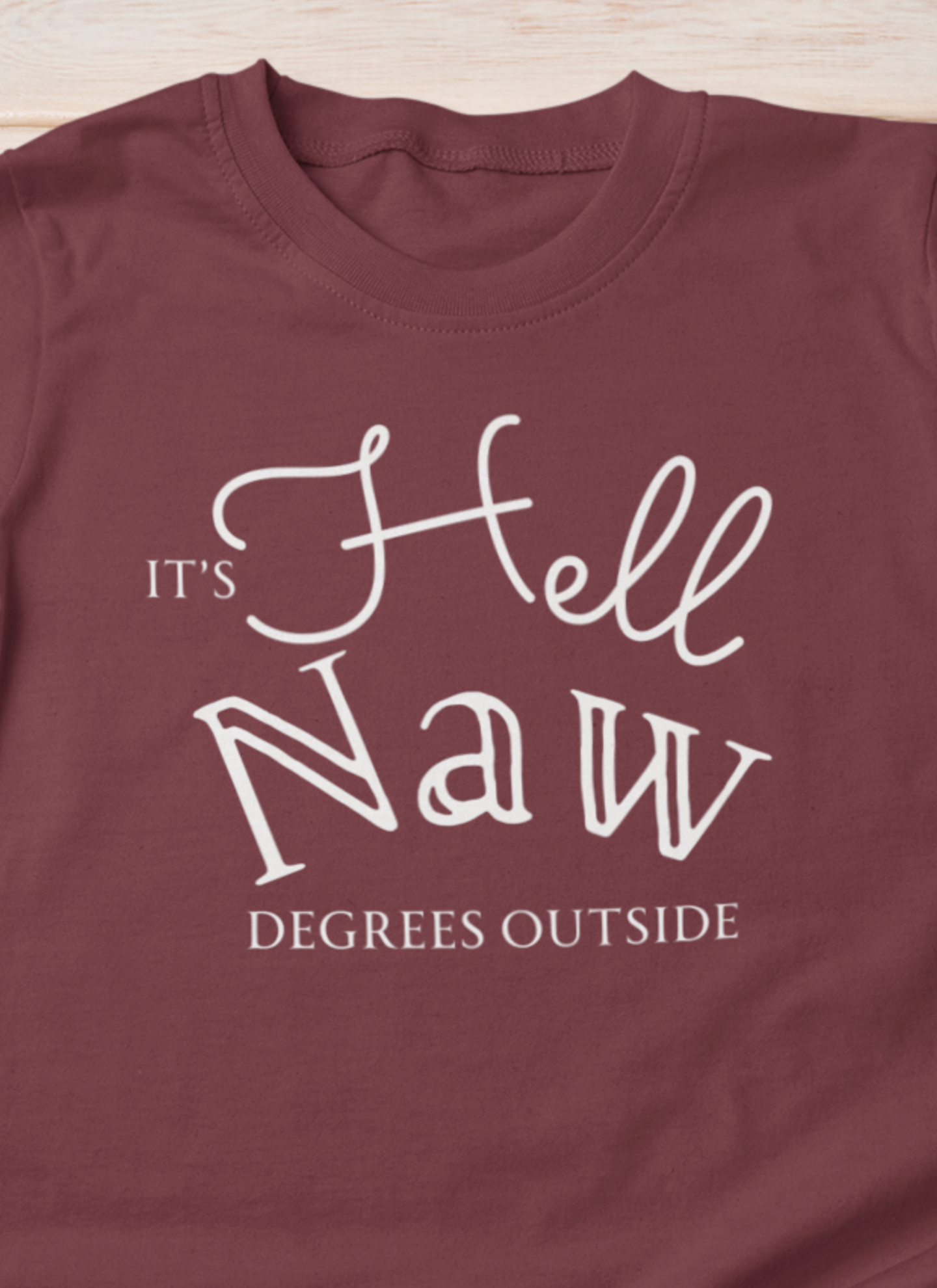 Comfortable unisex tee stating 'It's Hell Naw Degrees Outside' in color maroon
