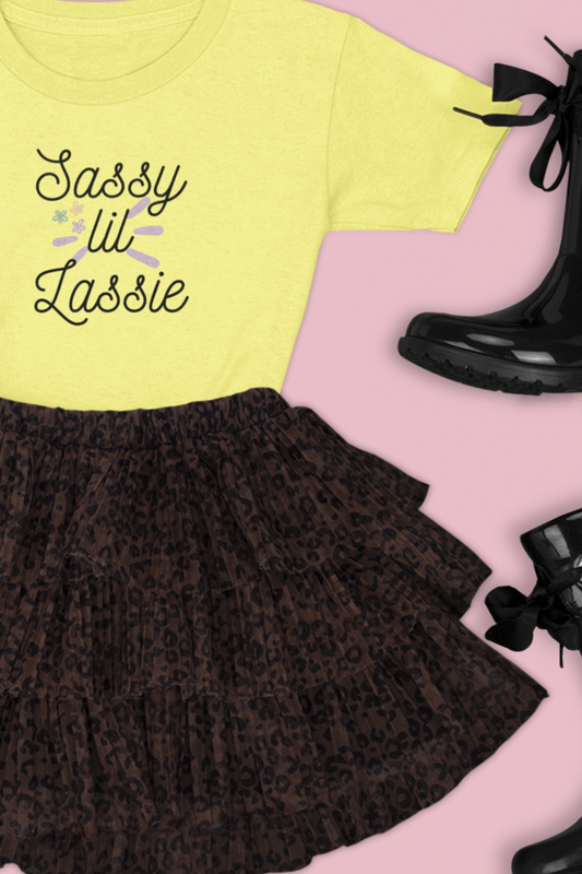 Comfortable funny graphic toddler tee stating 'Sassy Lil Lassie' in color yellow