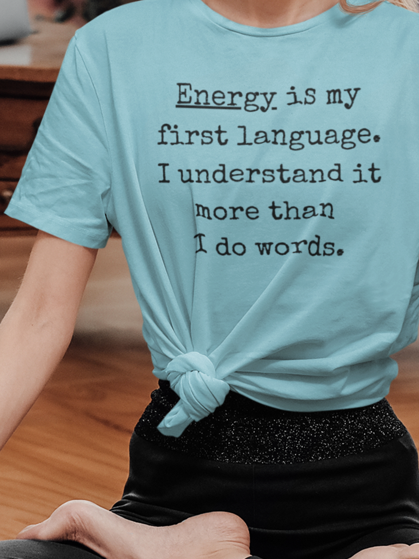woman doing yoga wearing a comfortable good vibes tee stating Energy is my first language. I understand it more than I do words. in color Turquoise