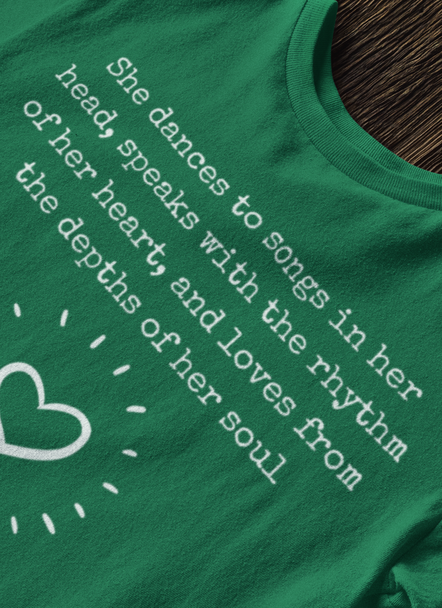 Comfortable good vibes graphic t-shirt stating 'She dances to songs in her head, speaks with the rhythm of her heart, and loves from the depths of her soul' in color kelly