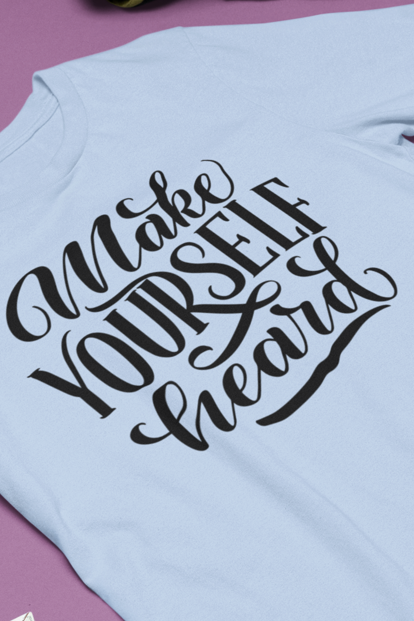 Good vibes graphic tee stating 'Make Yourself Heard' in color baby blue