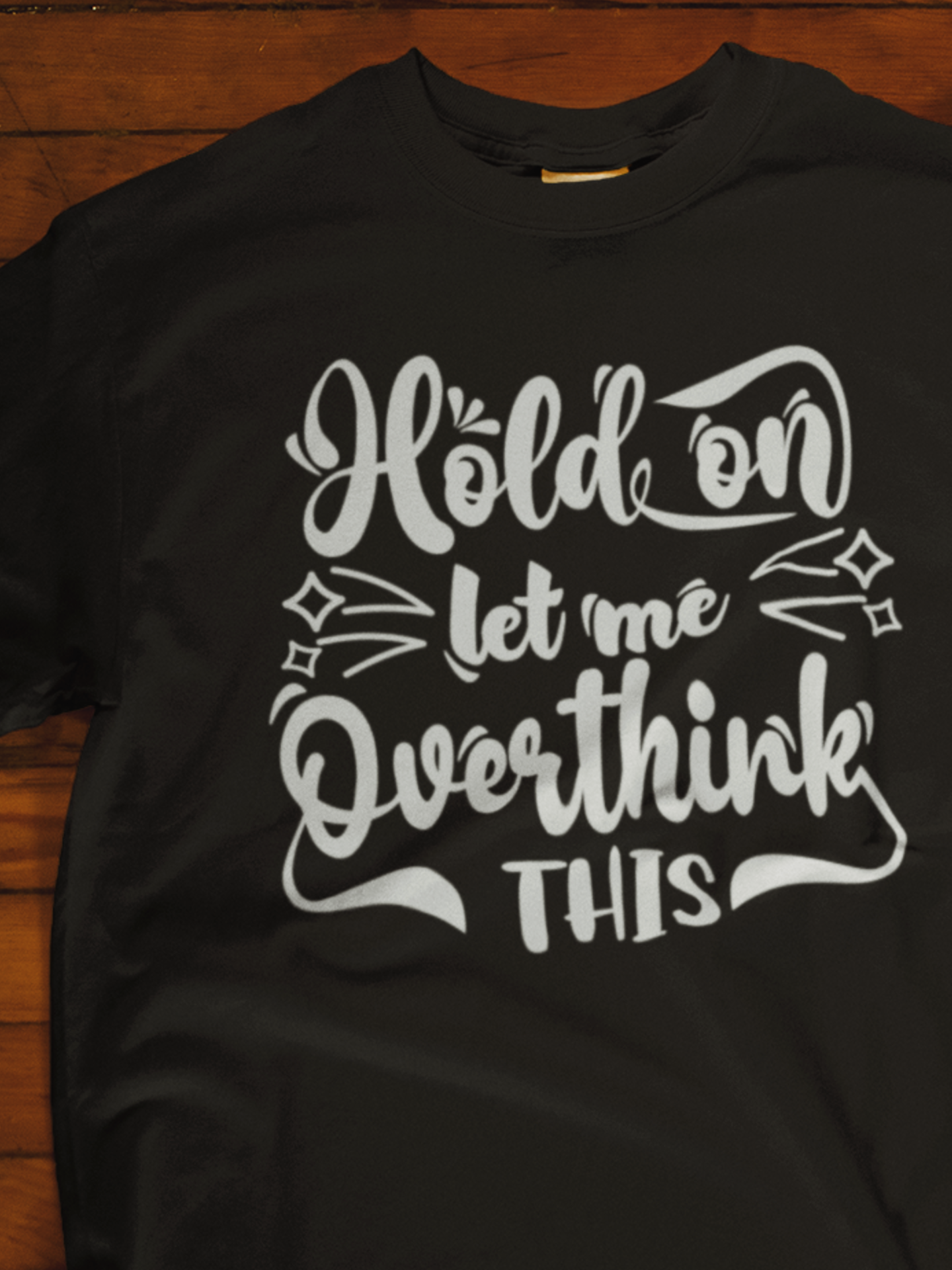 Unisex graphic tee stating 'Hold on let me overthink this' in color black