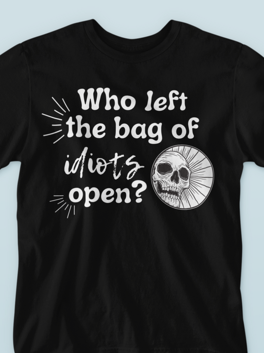 Unisex graphic tee stating 'Who left the bag of idiots open?' in color black