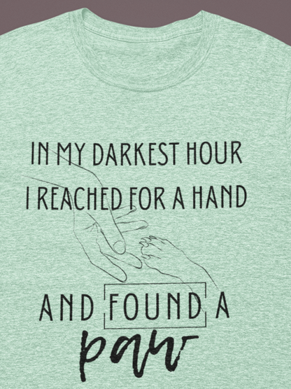 Comfortable graphic tee stating 'In my darkest hour I reached for a hand and found a paw' in color mint heather
