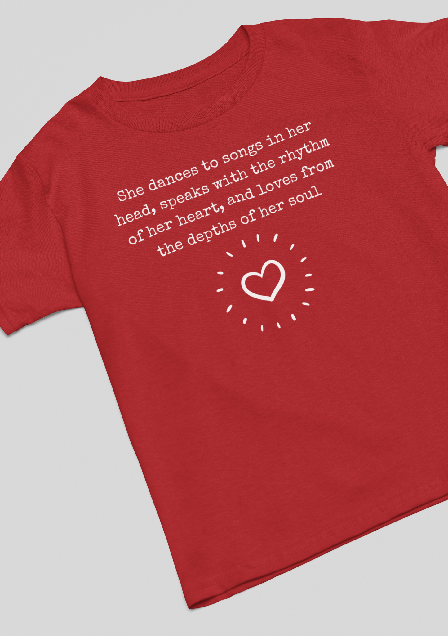 Comfortable good vibes graphic t-shirt stating 'She dances to songs in her head, speaks with the rhythm of her heart, and loves from the depths of her soul' in color red