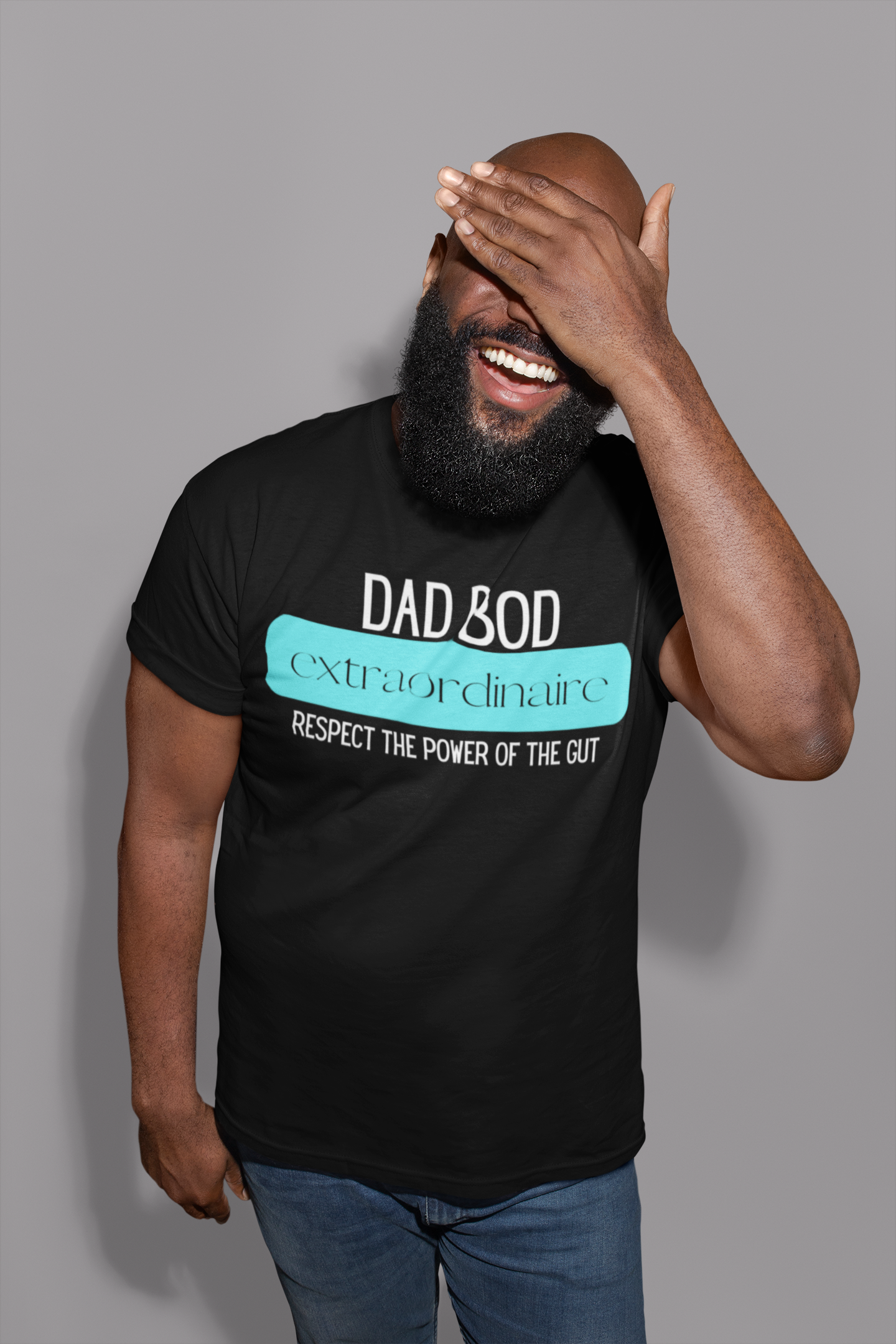 Man with beard wearing a funny graphic t-shirt stating Dad Bod Extraordinaire - Respect the Power of the Gut in color Black.
