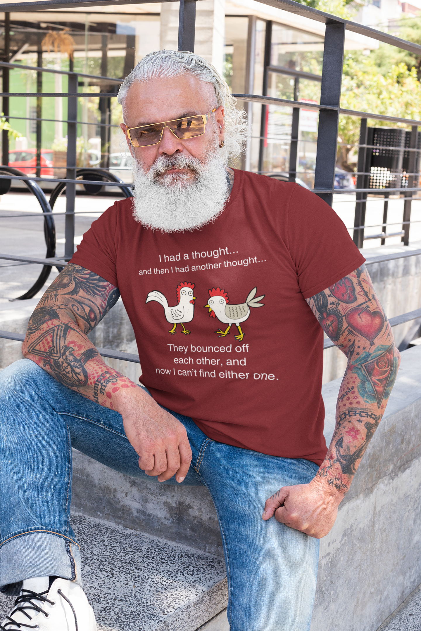 Man with white beard, tattoos, and sunglasses wearing a graphic t-shirt stating I had a thought...and then I had another thought...They bounced off each other, and now I can't find either one in color cardinal