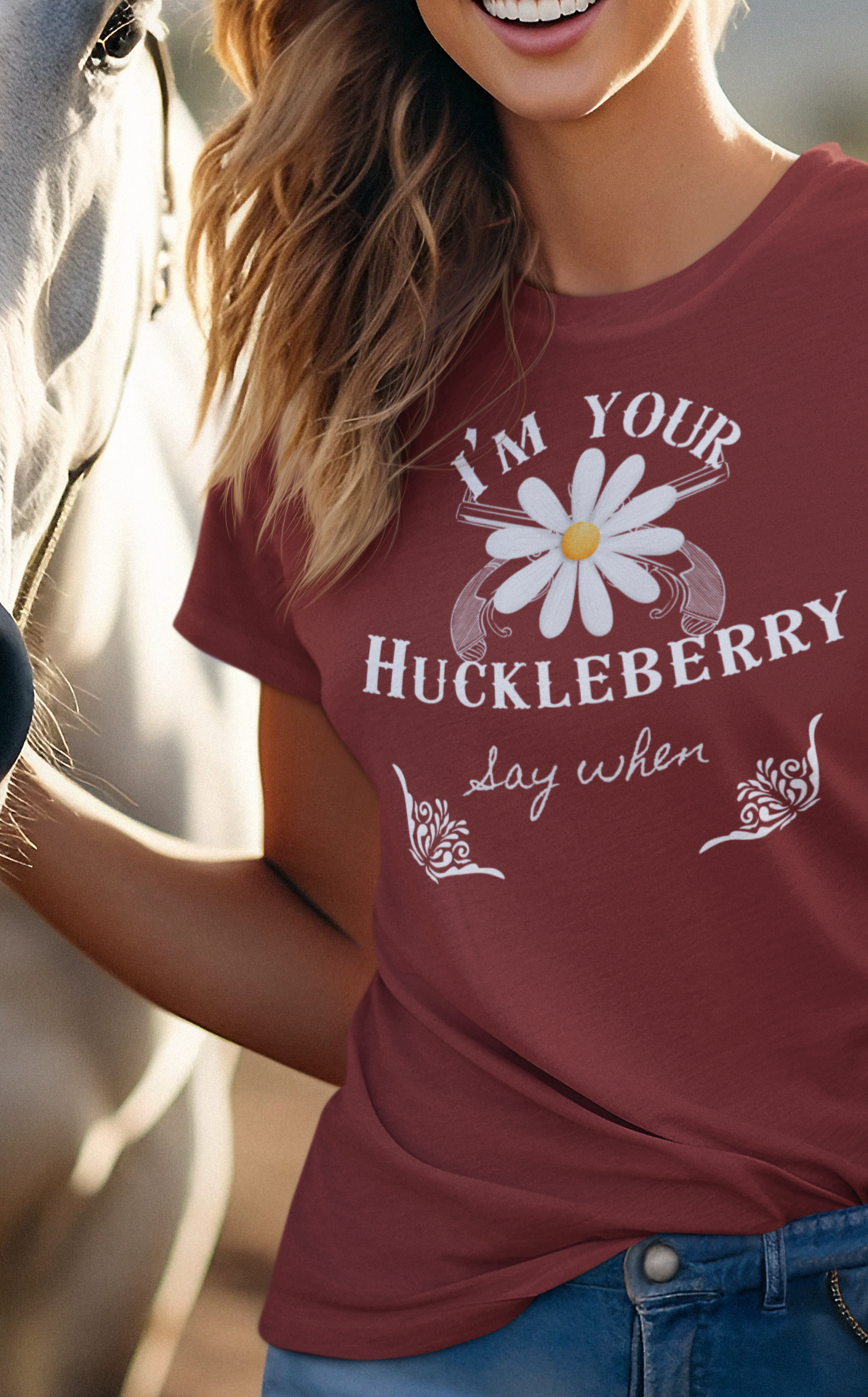 Smiling woman with horse wearing comfortable graphic t-shirt stating I'm Your Huckleberry - Say When in color Cardinal